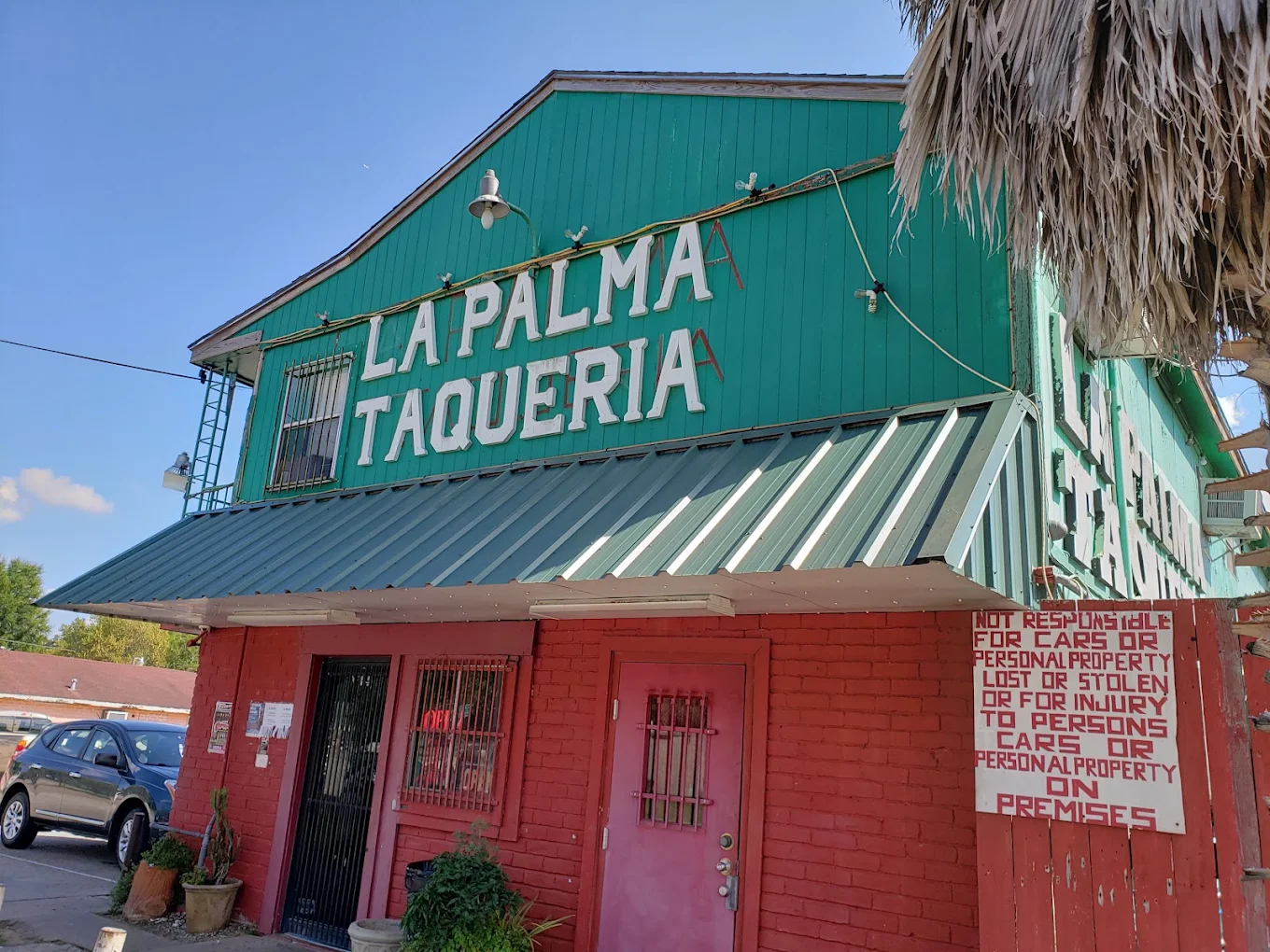 The red and green La Palma Taqueria building in daylight