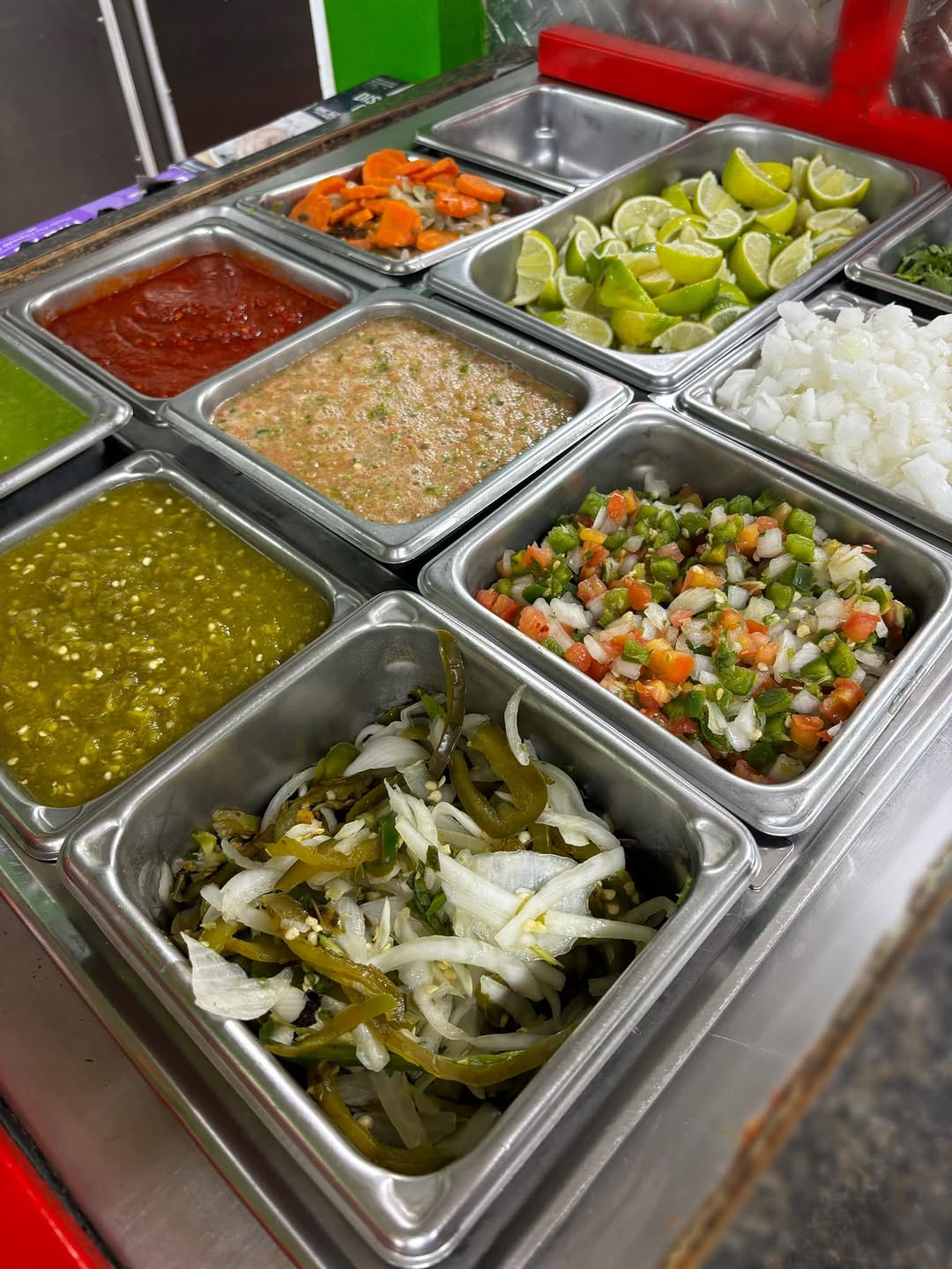 La Palma's self-serve salsa bar with red and green salsas, onions, limes and pickled vegetables